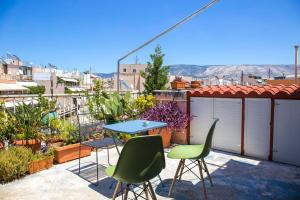 een terras met een tafel en stoelen op een balkon bij Sunny Top Floor Studio - Excellent Athens view in Athene