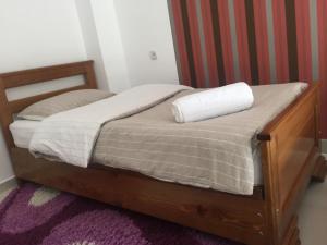 a bed with a white pillow on top of it at Oasis in Aspindza