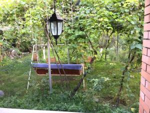 a swing in a garden with a street light at Oasis in Aspindza