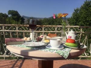a table with a plate of food and a glass of wine at Oasis in Aspindza
