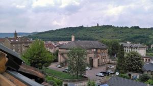 a city with cars parked in a parking lot at Villa Giselle in Hayange