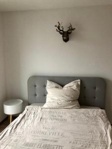 a bedroom with a bed with a white comforter at 1-Zi. Apartment, Echterdingen bei Flughafen/Messe Stgt. in Leinfelden-Echterdingen