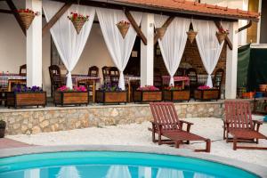 a group of chairs sitting next to a swimming pool at Apartments Bashoski in Ohrid