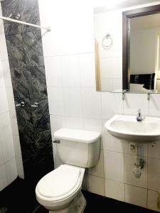 a bathroom with a toilet and a sink at Hotel Casa Paulina in Bogotá +43 photos