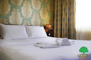 Voodi või voodid majutusasutuse Garden Hotel toas