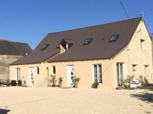 a large white building with a black roof at Villa Nature 02 in Meunet-sur-Vatan