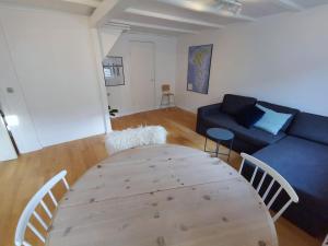 a living room with a table and a couch at City Center Apartment in Tórshavn