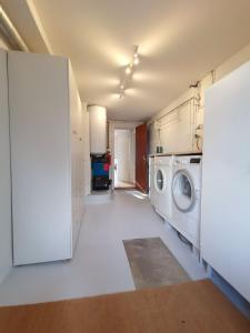 a laundry room with a washer and a washing machine at City Center Apartment in Tórshavn
