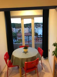 a table and chairs in a room with a balcony at Apartment Pula Center with private parking in Pula