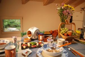 a table with a bowl of food and a bowl of fruit at B&B Ca'rina in Rovereto +36 photos