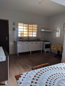 a kitchen with a sink and a stove at Casa para temporada Bonito MS in Bonito