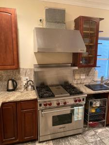 a kitchen with a stainless steel stove with a hood at Bloomingdale Beauty near Union Station in Washington