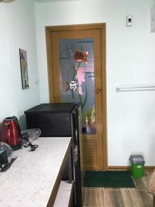 a room with a door with a fish painting on the wall at Labelle House in Ko Lanta