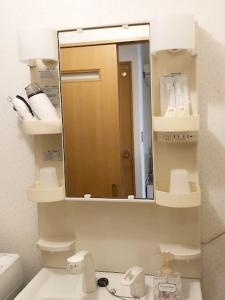 a bathroom with a mirror and a sink and a toilet at ラ・フィットヤマト103 in Fukuoka