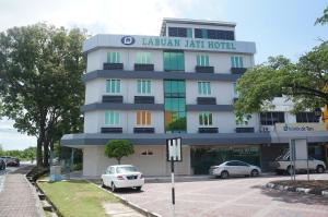 a building with cars parked in front of it at LABUAN JATI HOTEL in Labuan