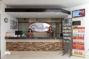 two women standing at the counter of aissim restaurant at Check Inn Hotel Dumaguete City in Dumaguete