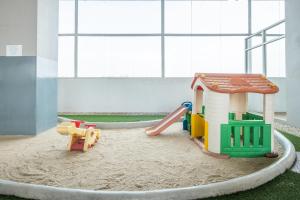 a play room with a sandbox and a play house at OYO 1405 Easton Park Residence in Bandung