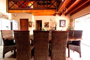 a dining room with a table and chairs at Lovely holiday home bordering Kruger National Park in Marloth Park