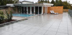 a patio with a swimming pool and a house at Berghaus Knopfmacher in Fridingen an der Donau