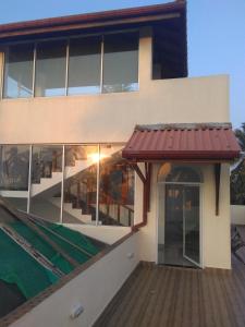 a house with a red awning in front of it at VILLA ARIANNA in Wattala
