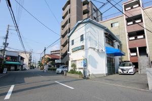a small white building on the side of a street at Osaka - House / Vacation STAY 4824 in Osaka