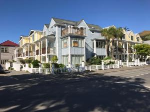 a row of houses on the side of a street at Bruce Waterfront Apartments in Akaroa