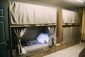 a bunk bed in a room with towels at Good Hostel in Vladivostok