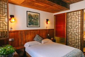 a bedroom with a bed and two windows at September Hui zhou Homestay in She