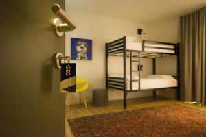 a room with two bunk beds and a door at Vanilla Sky Boutique Hostel in Tirana