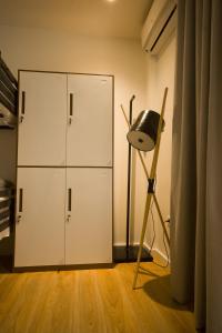 a room with a closet and a chair and a cabinet at Vanilla Sky Boutique Hostel in Tirana