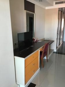 a room with a desk with a television on it at Tonkoon Hotel in Udon Thani