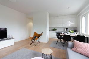 a living room and kitchen with a table and chairs at House of Saana in Rovaniemi