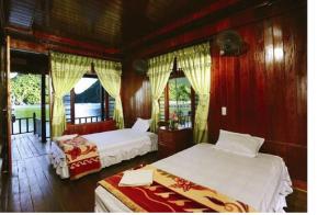 
a bedroom with a bed and a window at Cat Ba Sandy Beach Resort in Cat Ba
