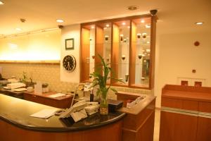 a waiting room with a reception counter in a store at SUPER OYO Collection O 166 Hotel Princess in Palembang