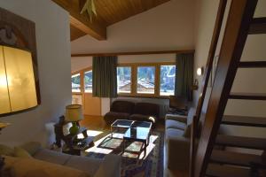 a living room with a couch and a table at EMERALD CENTRALE in Madonna di Campiglio