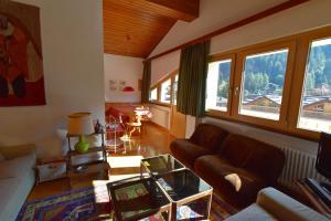 a living room with a couch and a table at EMERALD CENTRALE in Madonna di Campiglio