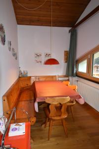 a dining room with a table and chairs in a room at EMERALD CENTRALE in Madonna di Campiglio