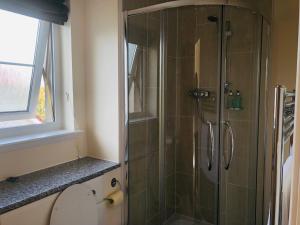 a shower with a glass door in a bathroom at Taigh d'Luxe in Inverness +47 photos