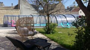 a patio with two chairs and a water park at Hotel des Thermes et du Casino in Luc-sur-Mer