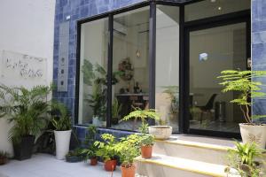 un gruppo di piante in vaso situate all’esterno di un edificio di Yes Yes I Am Willing a Tainan