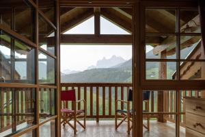 a view from the balcony of a cabin with mountains at Villa Messner in Funes
