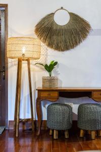 a desk with a potted plant and a lamp at Vision Villa Resort in Keramas