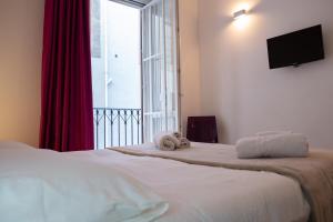 a bed with a teddy bear sitting on top of it at B&B Teatro in Palermo
