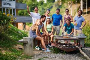 a group of people standing around a picnic table at Oberstdorf Hostel in Oberstdorf