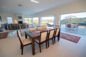 a dining table and chairs in a living room at Brackenridge 11 Protea Dale in Plettenberg Bay