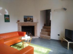 a living room with a couch and a fireplace at Casa Vacanze La Villa in Morino