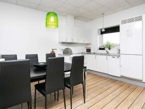 a kitchen with a dining room table and chairs at 6 person holiday home in Ringk bing in Ringkøbing