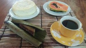 a table with two plates of food and a cup of coffee at Chácara das flores in Gonçalves +55 photos