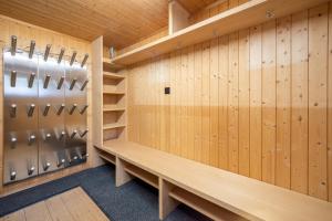 a dressing room with wood paneling and lockers at Chalet Cauma in Flims