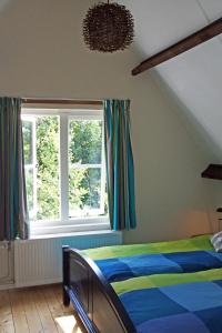 En eller flere senge i et værelse på Vakantiehuis de Rommelpot